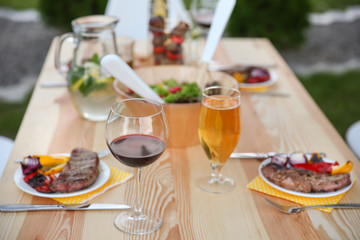 Table with food and drinks served for picnic