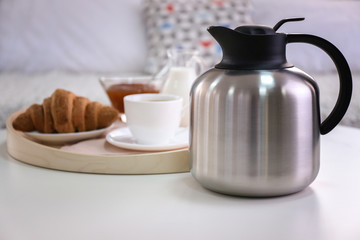 Breakfast with croissant and coffee on wooden table