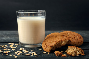 Oatmeal cookies with milk on table