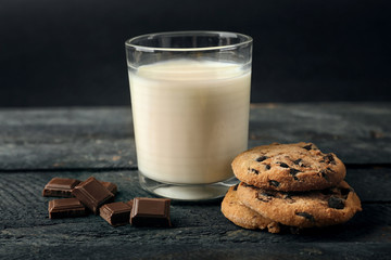 Chocolate cookies with milk on table