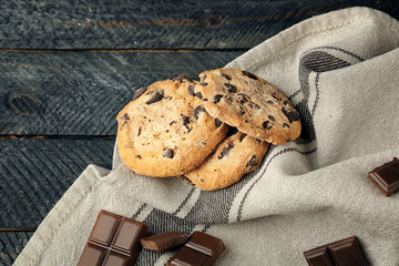Chocolate cookies on napkin on wooden background