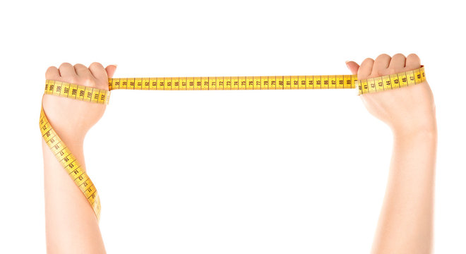 Female hands holding measuring tape on white background