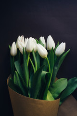 white tulips bouquet on a dark background