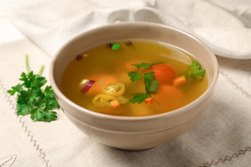 Bowl with fresh vegetable soup on napkin