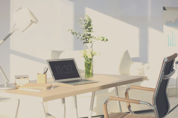Workplace with laptop on table in modern room