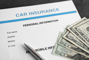 Car insurance form and money on table