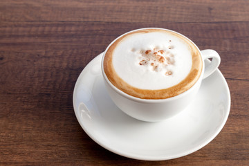 Coffee cup of cappuccino on wooden background with copy space