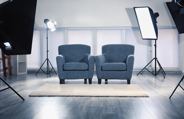 Photo studio with modern interior and lighting equipment