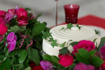 Close up white wedding cake and table decorated with flowers.