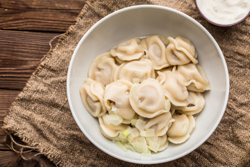 Meat dumplings - russian pelmeni, ravioli with meat on a white plate