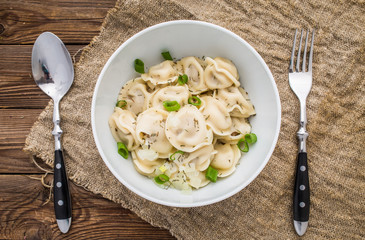 Meat dumplings - russian pelmeni, ravioli with meat on a white plate