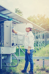 engineer working on checking and maintenance equipment at green energy solar power plant