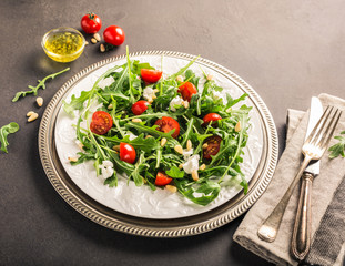 fresh vegetable salad with rucola, tomatos and goat cheese. Healthy food concept. Copy space. Retro style toned.