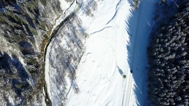 Aerial view of winter road and car passing