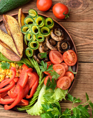 Buddha bowl of mixed vegetable on the wooden table.
