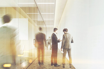 Men in a company corridor, toned