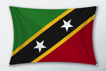 Saint kitts and Nevis national flag. Symbol of the country on a stretched fabric with waves attached with pins. Realistic vector illustration.