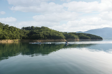 Three young boy at the rowing competition at the lake