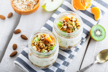 Healthy meal made of granola, yogurt and fruits. Delicious food for breakfast. Traditional American snack. Top view.