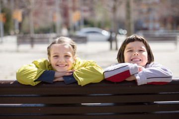 children posing on street bench