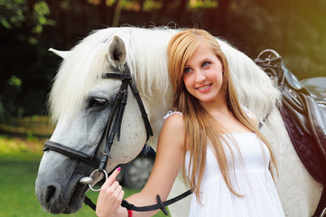 young woman in a white dress on a white horse
