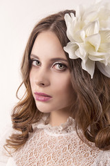 girl in white dress and with white flower in her hair