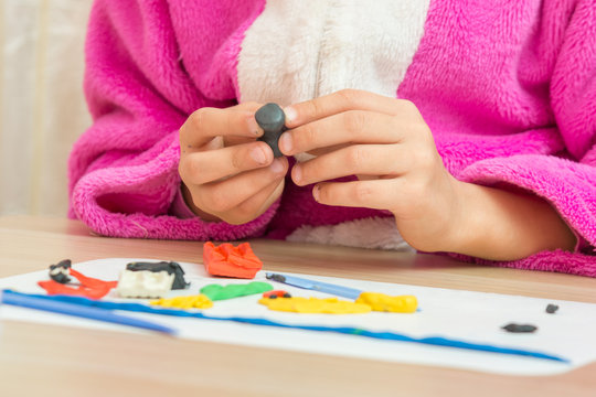 A child holding a blank crafts from plasticine