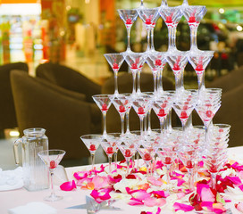 Catering table still life with a pyramid of champagne glasses