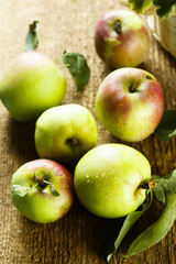 Fresh apples with green leaves