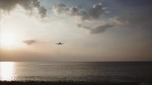spotting. sunset, the plane is landing low to the beach. 
