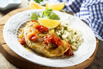 Trout, cooked with smoked paprika, tomatoes and couscous