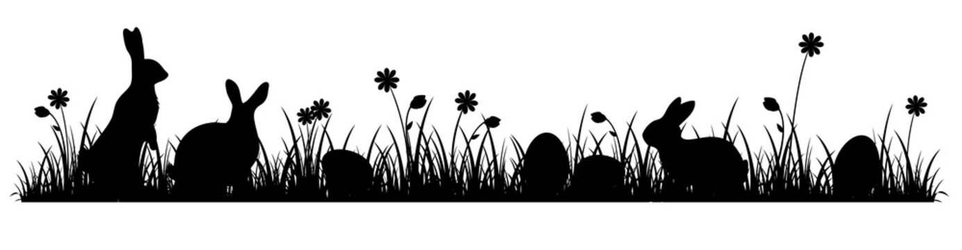 Silhouettes of cute Easter bunnies on a flower meadow 