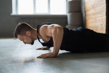 Obraz premium Young man fitness workout, push ups or plank