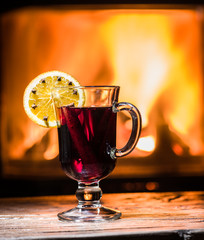 Hot mulled wine with orange slice, cloves and cinnamon stick.