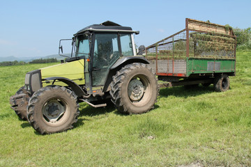 An Agricultural Tractor and Trailer on a Farming Field.