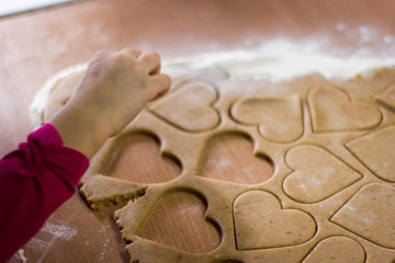 Fototapeta na wymiar Girl with hearts of dough
