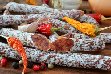 Homemade salametti  with spices and vegetables, close up
