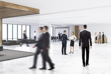 Fototapeta premium People in an office hall with a whiteboard