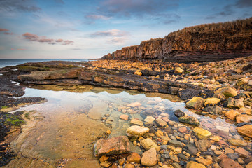 Fototapeta na wymiar Rock Pool below Ebb's Nook, also known as Beadnell Point, is a headland just north of Beadnell harbour