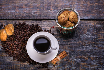 Coffee cup, coffee beans and biscuits, cookies  on wooden background