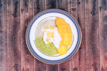 Ripe golden mango with green and white of sticky rice.