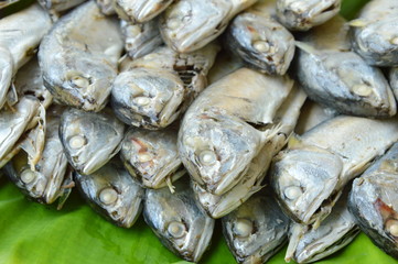 boiled mackerel on fresh banana leaf in market