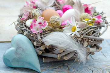 Happy Easter: nest with Easter eggs, feathers, flowers and heart :)