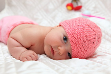 New born baby girl in pink hat