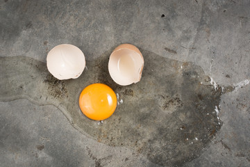 Egg fall and broken on concrete floor