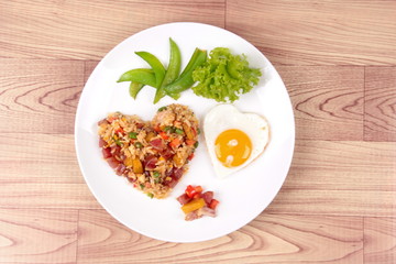 Chinese sausage fried rice and sunny egg in heart shapes.