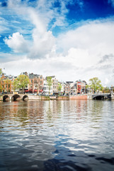 Naklejka premium embankment of Amstel canal in Amsterdam, Holland, retro toned