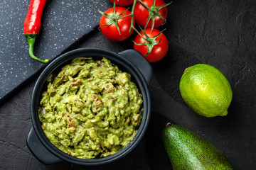 Bowl of guacamole with fresh ingredients