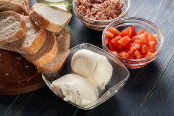 Ingredients ready for preparing bruschetta with tuna, mozzarella