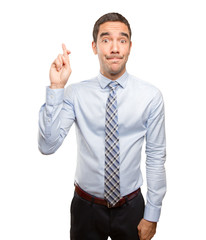 Hopeful businessman finger cross gesture